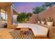 L-shaped patio seating area with wood accents and desert plants at 10758 E Tamarisk Way, Scottsdale, AZ 85262