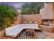 Relaxing patio with seating area, fire pit, and desert landscaping at 10758 E Tamarisk Way, Scottsdale, AZ 85262