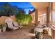 Evening view of a relaxing patio with seating at 10758 E Tamarisk Way, Scottsdale, AZ 85262