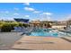 Community pool with lounge chairs and umbrellas at 10758 E Tamarisk Way, Scottsdale, AZ 85262