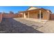 House with a covered patio and a sizable backyard at 11793 W Larkspur Rd, El Mirage, AZ 85335