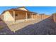 Home exterior showcasing a covered patio and a large backyard at 11793 W Larkspur Rd, El Mirage, AZ 85335