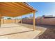 Covered patio and spacious backyard with gravel at 11793 W Larkspur Rd, El Mirage, AZ 85335