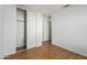 Bedroom with wood flooring, closet, and door to hallway at 11793 W Larkspur Rd, El Mirage, AZ 85335