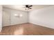 Bedroom with wood-look floors and ceiling fan at 11793 W Larkspur Rd, El Mirage, AZ 85335