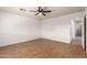 Spacious bedroom with wood-look floors and ceiling fan at 11793 W Larkspur Rd, El Mirage, AZ 85335