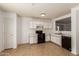 Kitchen with white cabinets and black appliances at 11793 W Larkspur Rd, El Mirage, AZ 85335