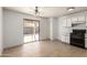 Kitchen with white cabinets, tile floors, and view of backyard at 11793 W Larkspur Rd, El Mirage, AZ 85335