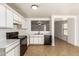 Kitchen with white cabinets and black appliances at 11793 W Larkspur Rd, El Mirage, AZ 85335