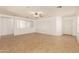 Bright living room with tile floors and ceiling fan at 11793 W Larkspur Rd, El Mirage, AZ 85335