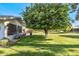 Backyard with an orange tree and grassy area at 12719 W Shadow Hills Dr, Sun City West, AZ 85375