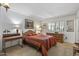 Bedroom with wood dresser, a bed with striped bedding and a desk at 12719 W Shadow Hills Dr, Sun City West, AZ 85375