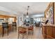 Bright dining room featuring a glass-top table and hardwood floors at 12719 W Shadow Hills Dr, Sun City West, AZ 85375