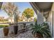 Relaxing front patio featuring brick flooring and greenery at 12719 W Shadow Hills Dr, Sun City West, AZ 85375