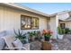 Cozy front patio with seating, plants, and a side yard view at 12719 W Shadow Hills Dr, Sun City West, AZ 85375