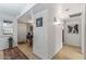 Bright hallway with wood flooring and artwork at 12719 W Shadow Hills Dr, Sun City West, AZ 85375