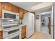 Bright kitchen features white appliances and wood cabinets at 12719 W Shadow Hills Dr, Sun City West, AZ 85375