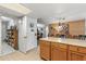 Kitchen island with wood cabinets and access to pantry at 12719 W Shadow Hills Dr, Sun City West, AZ 85375