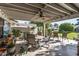 Relaxing covered patio with table, chairs, and lush greenery at 12719 W Shadow Hills Dr, Sun City West, AZ 85375