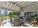 Covered patio with outdoor dining set and lush landscaping at 12719 W Shadow Hills Dr, Sun City West, AZ 85375