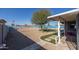 Backyard features a covered patio, gravel landscaping, and a small patch of grass at 13034 N 98Th Dr, Sun City, AZ 85351