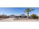 Single-story home with gray exterior, two-car garage, and landscaped front yard at 13034 N 98Th Dr, Sun City, AZ 85351