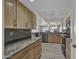 Bright kitchen, granite countertops, and wood cabinets at 13034 N 98Th Dr, Sun City, AZ 85351