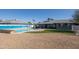 Relaxing pool area with a beach-themed wall and grassy area at 13034 N 98Th Dr, Sun City, AZ 85351