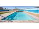 Inviting rectangular pool with a painted beach-themed wall at 13034 N 98Th Dr, Sun City, AZ 85351