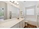 Bright bathroom featuring a large mirror, double vanity, tub, and a window for natural light at 1328 E Binner Dr, Chandler, AZ 85225