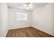 Bright bedroom featuring ceiling fan, wood-look flooring, and a window for natural light at 1328 E Binner Dr, Chandler, AZ 85225