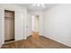 Bedroom with closet and door to living space featuring neutral finishes and wood-look flooring at 1328 E Binner Dr, Chandler, AZ 85225