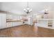 Bright kitchen with white cabinets and appliances, open to the living area, with wood-look floors at 1328 E Binner Dr, Chandler, AZ 85225