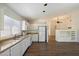 White kitchen with stainless steel appliances and wood floors at 1328 E Binner Dr, Chandler, AZ 85225