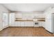 Well-lit kitchen featuring white cabinets, neutral countertops, and a spacious layout at 1328 E Binner Dr, Chandler, AZ 85225
