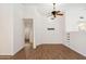 Open living room with ceiling fan, wood-look floors, and built-in shelving at 1328 E Binner Dr, Chandler, AZ 85225