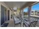 Covered patio with a seating area and fire pit overlooking the backyard swimming pool at 14 E Peppergrass Pl, San Tan Valley, AZ 85143