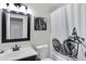 Stylish bathroom featuring a motorcycle-themed shower curtain and artwork at 14 E Peppergrass Pl, San Tan Valley, AZ 85143