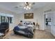 Bright bedroom with a guitar-themed bedspread, ceiling fan, and natural light at 14 E Peppergrass Pl, San Tan Valley, AZ 85143