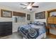 Comfortable bedroom with motorcycle-themed decor, natural light, and a ceiling fan at 14 E Peppergrass Pl, San Tan Valley, AZ 85143