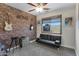 Bedroom with exposed brick, a futon, and guitars mounted on the wall at 14 E Peppergrass Pl, San Tan Valley, AZ 85143