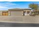 Charming single-story home showcasing a neutral color palette, a two-car garage, and desert landscaping at 14 E Peppergrass Pl, San Tan Valley, AZ 85143