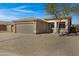 Single-story home exhibiting desert landscaping, a 2-car garage, neutral exterior and cozy outdoor seating at 14 E Peppergrass Pl, San Tan Valley, AZ 85143