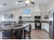 Bright kitchen with stainless appliances, open shelving, eat in table, and modern finishes at 14 E Peppergrass Pl, San Tan Valley, AZ 85143