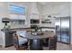 Cozy kitchen with stainless appliances, custom cabinetry, eat in table, and ample storage at 14 E Peppergrass Pl, San Tan Valley, AZ 85143