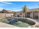 Serene backyard pool with a covered patio, palm trees, and a tranquil atmosphere at 14 E Peppergrass Pl, San Tan Valley, AZ 85143