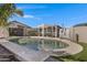 Inviting pool area featuring a pergola, a seating set, and a well-maintained landscape at 14 E Peppergrass Pl, San Tan Valley, AZ 85143