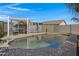 Beautiful backyard pool with a pergola-covered seating area, perfect for relaxing and entertaining at 14 E Peppergrass Pl, San Tan Valley, AZ 85143