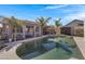 Backyard oasis featuring a pool, a covered patio, and lush landscaping, creating a private retreat at 14 E Peppergrass Pl, San Tan Valley, AZ 85143