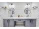 Modern bathroom with double vanity, gray cabinets, and white subway tile at 1436 E Rosemonte Dr, Phoenix, AZ 85024